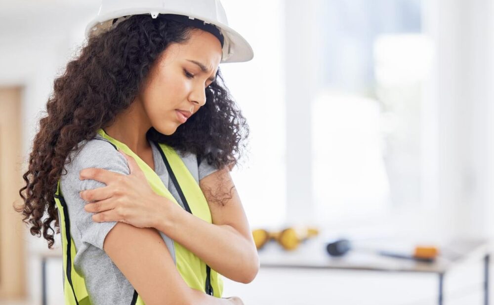 Construction worker woman and shoulder injury