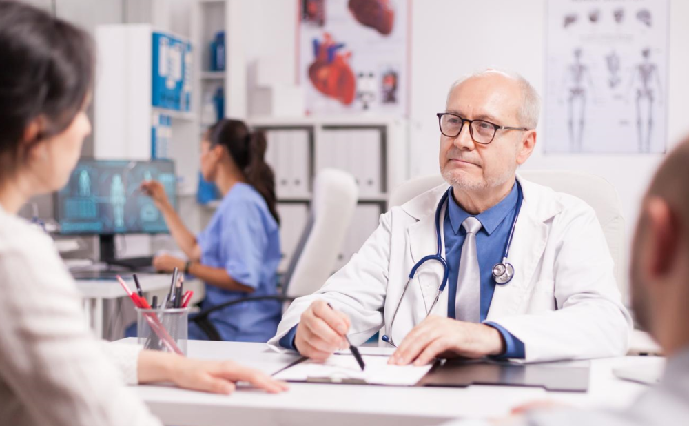 doctor-with-grey-hair-during-patient-examination