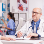 doctor-with-grey-hair-during-patient-examination